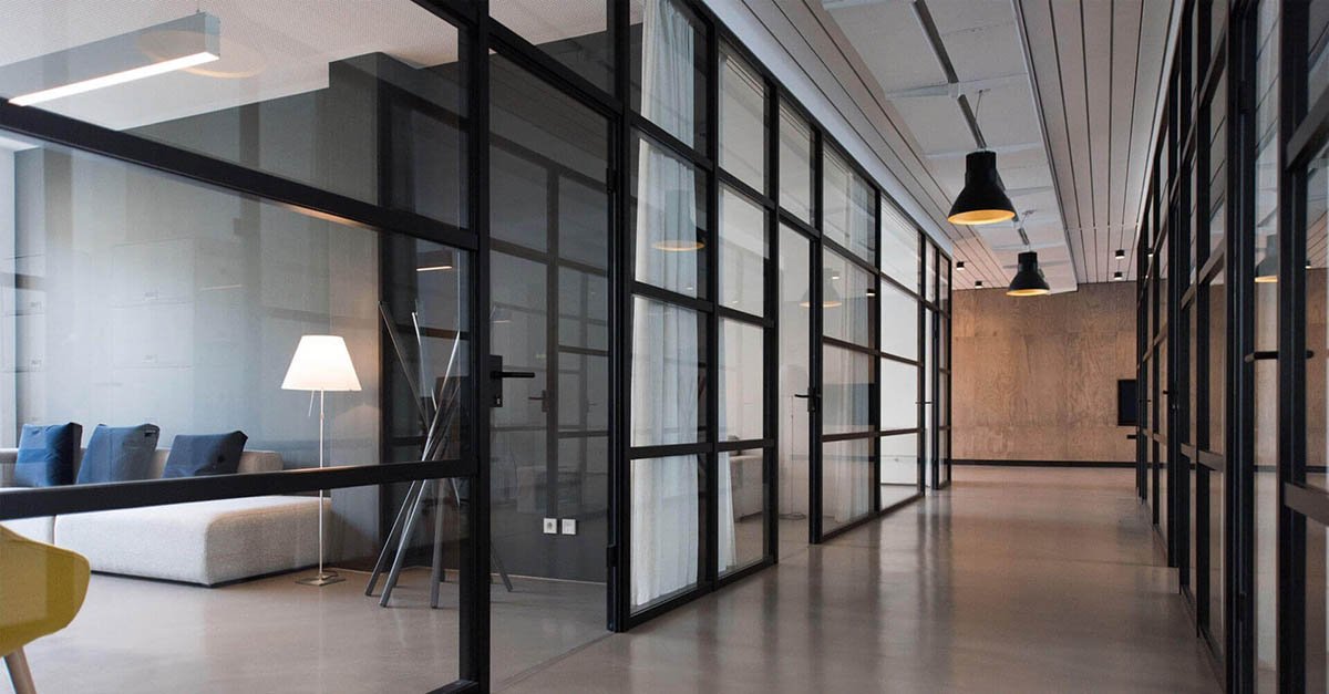 Glass-fronted meeting rooms with black steel framing