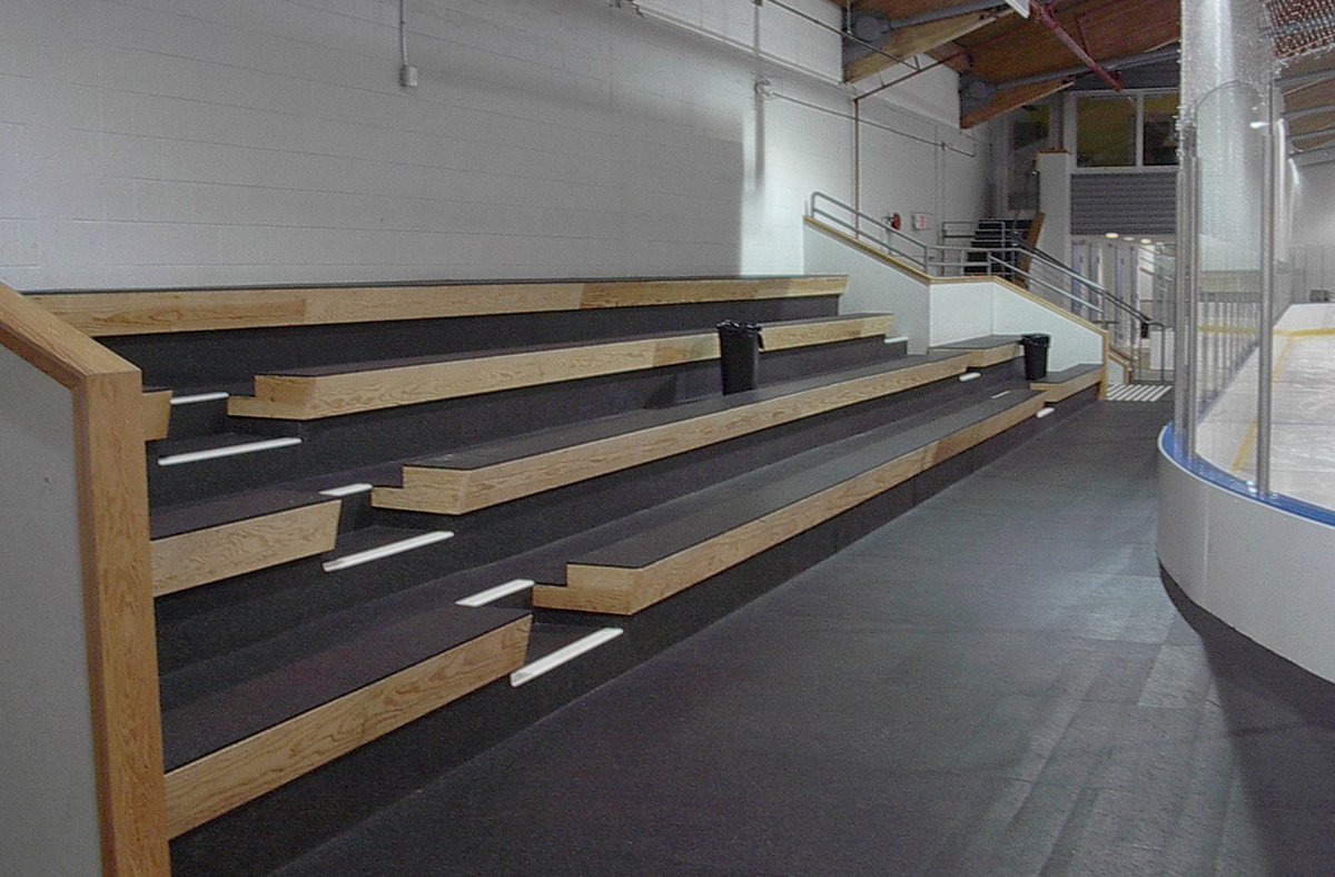 Arena bleacher steps and rinkside walkway in recycled rubber matting