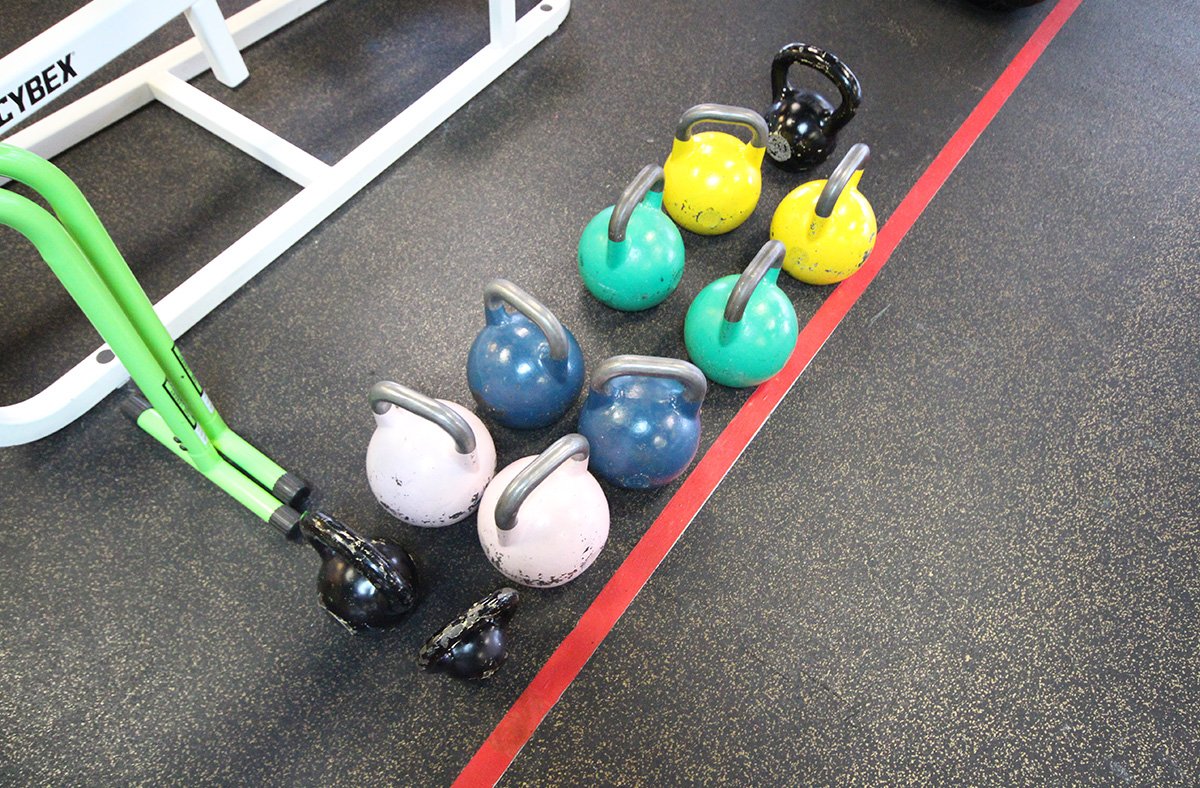 Kettlebells on rolled sport mat with game line