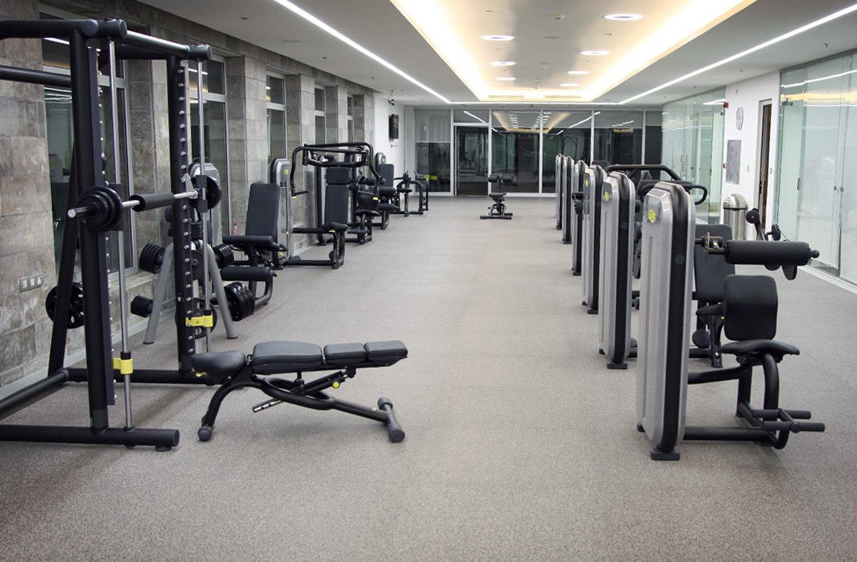 Rubber training floor with strength equipment