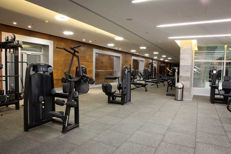 Hotel fitness center with rubber flooring and strength machines