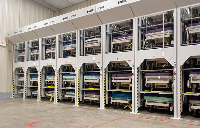 Loaded Vidir bedlifts in a hospital storage room